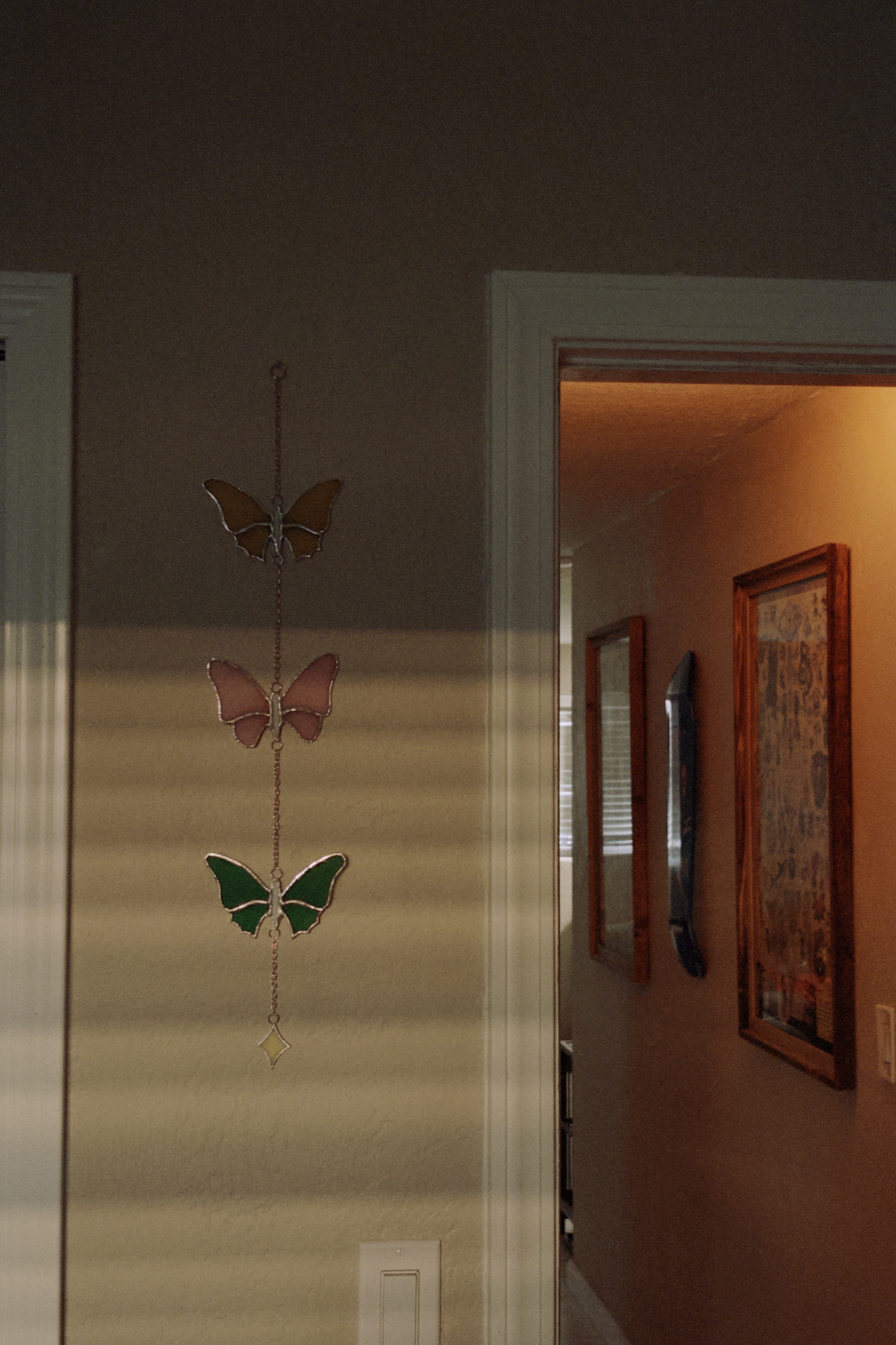 stained glass butterfly garland in amber, pink, and green