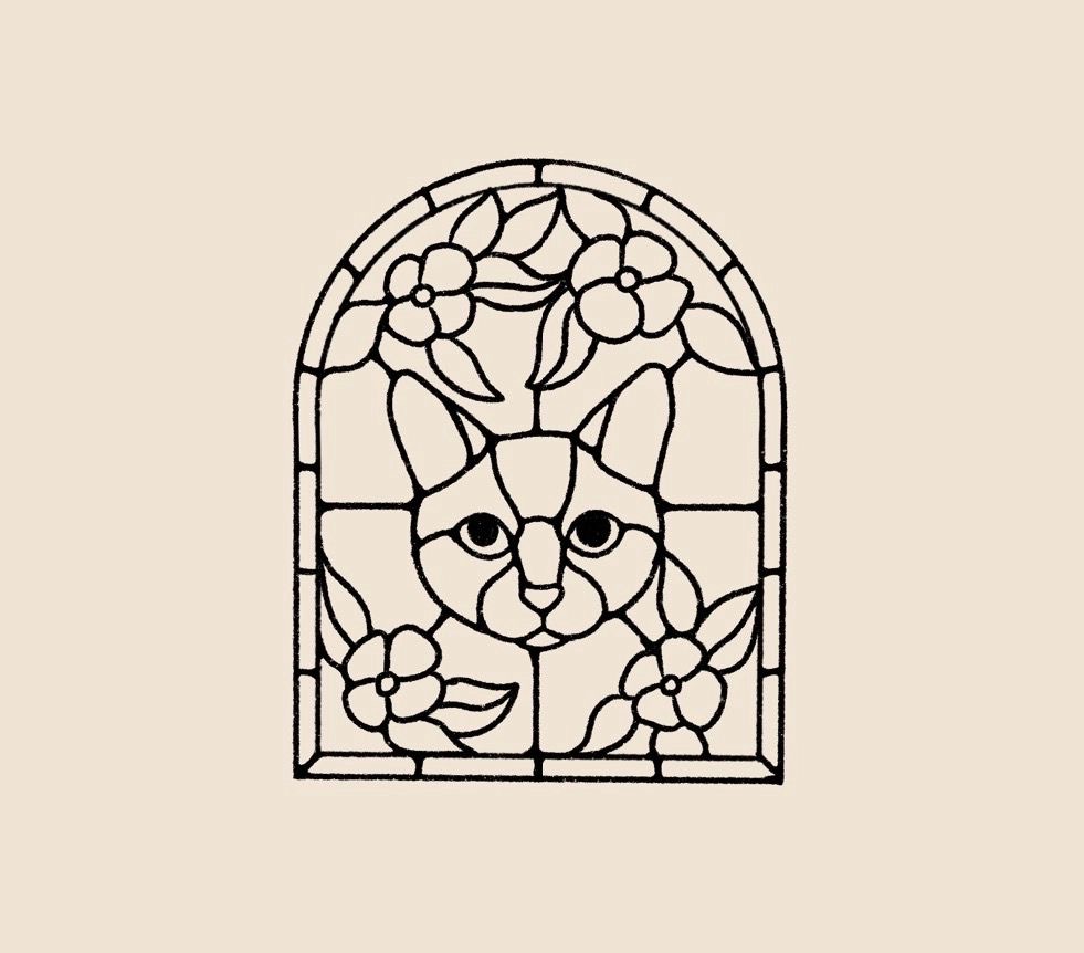 stained-glass arched window with a cat